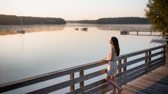 Une jeune femme au lever du soleil sur le lac de Trémelin